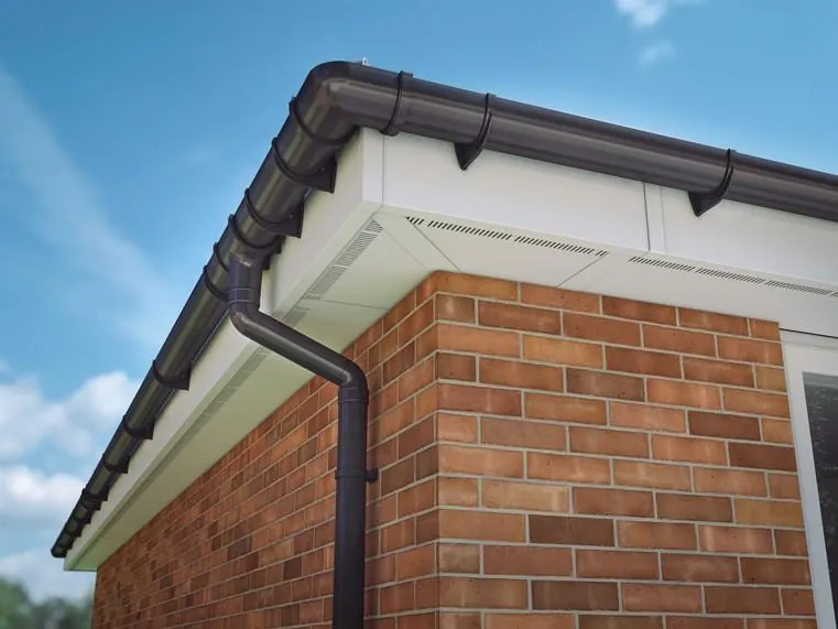 Close-up of a new fascia, soffit and guttering on a brick wall