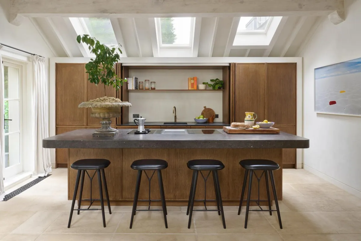 Kitchen with a timber island, bar stools and skylights