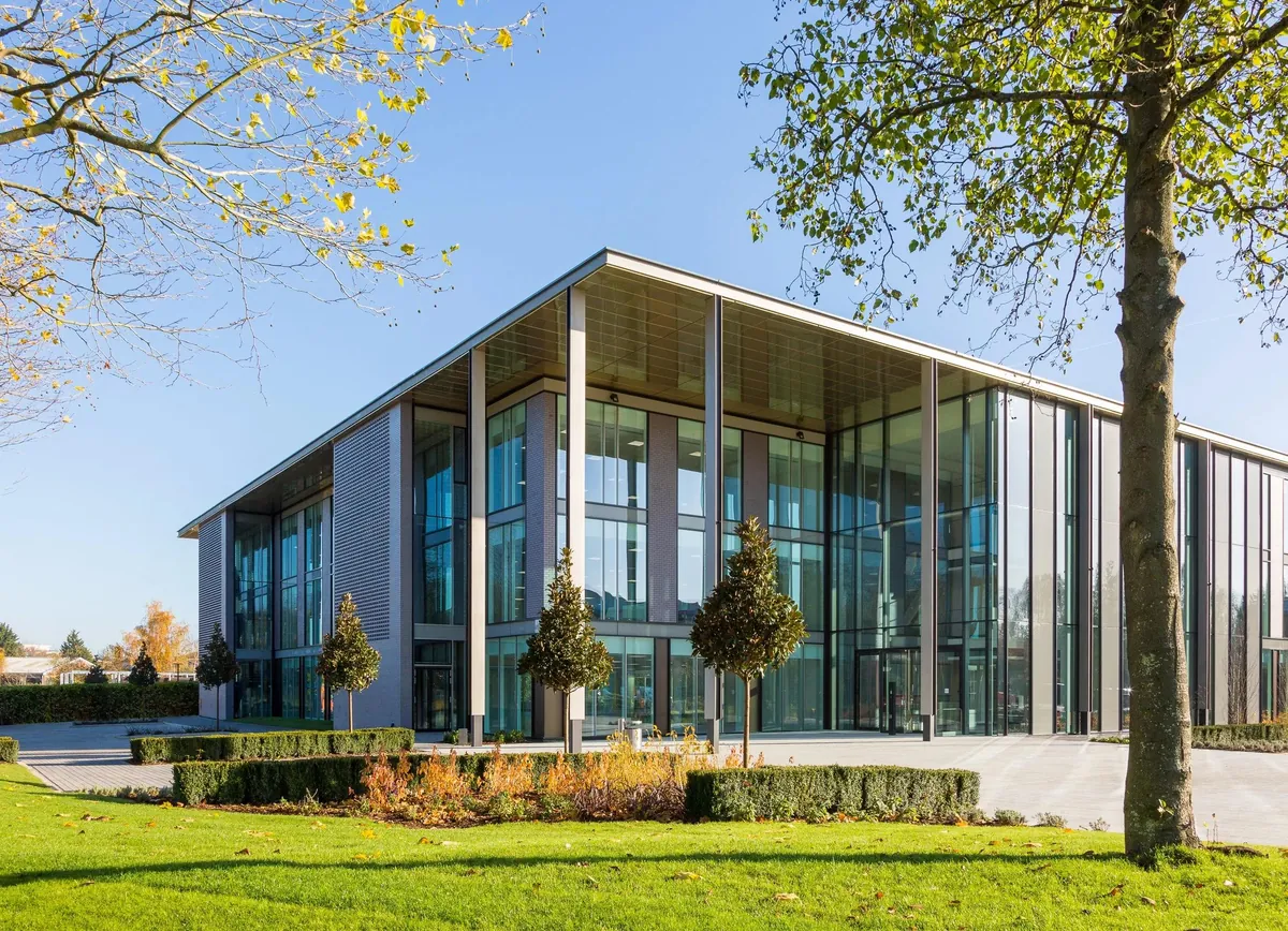 Glazed public building set in mature parkland