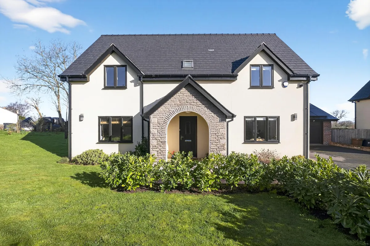 Well-maintained rendered family home with a neat front garden